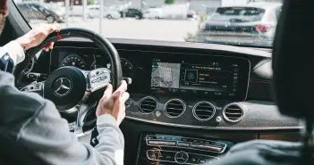 person in gray long sleeve shirt driving car