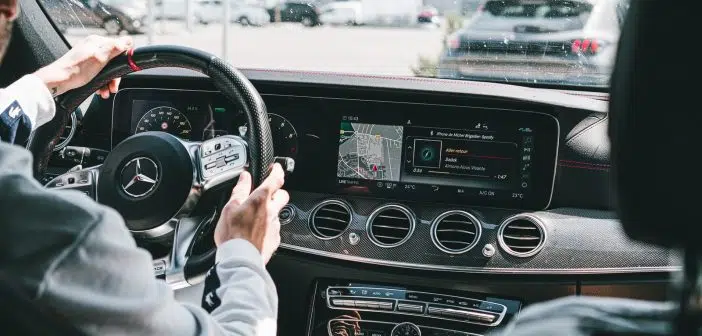 person in gray long sleeve shirt driving car