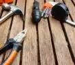 assorted-type carpentry tools on brown surface