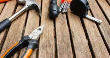 assorted-type carpentry tools on brown surface