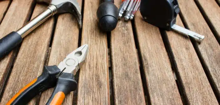 assorted-type carpentry tools on brown surface